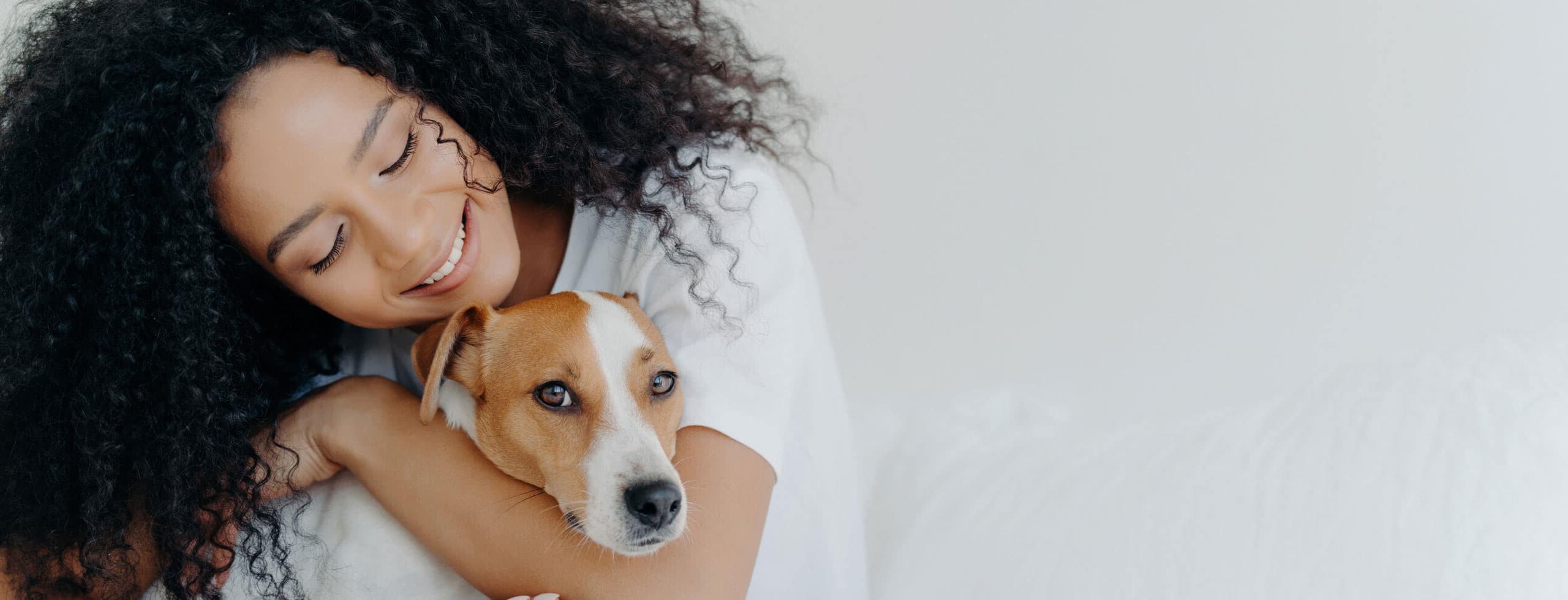 Woman cuddling a dog